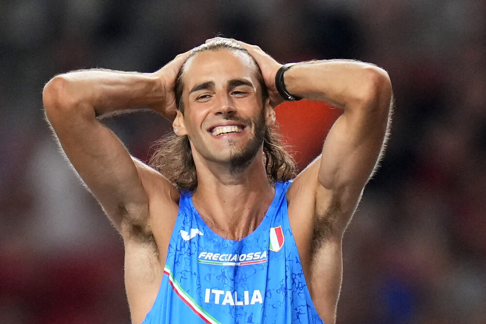 Gianmarco Tamberi, of Italy, celebrates winning the gold medal in the Men's high jump final during the World Athletics Championships in Budapest, Hungary, Tuesday, Aug. 22, 2023. (AP Photo/Petr David Josek)